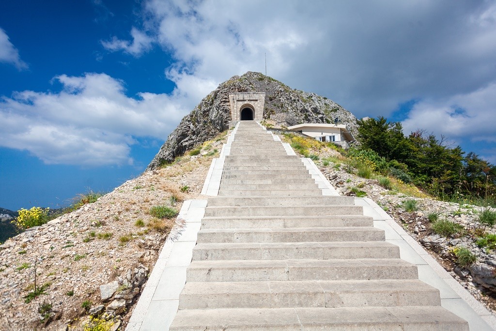 A photo of landscape and stairs that lead to the top hill, and entrance of the Mausoleum 